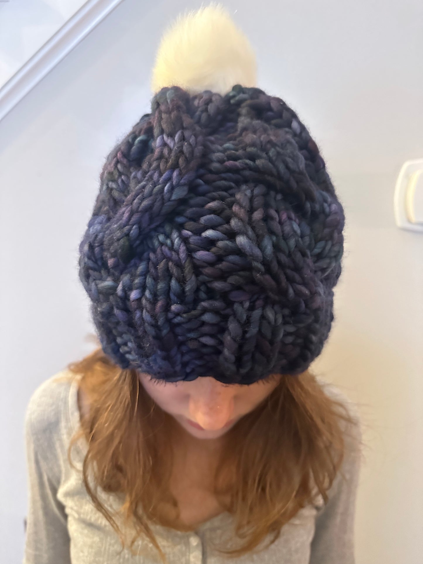 Midnight Frost: Cable Knit Hat with Variagated Blue and White Pom-Pom